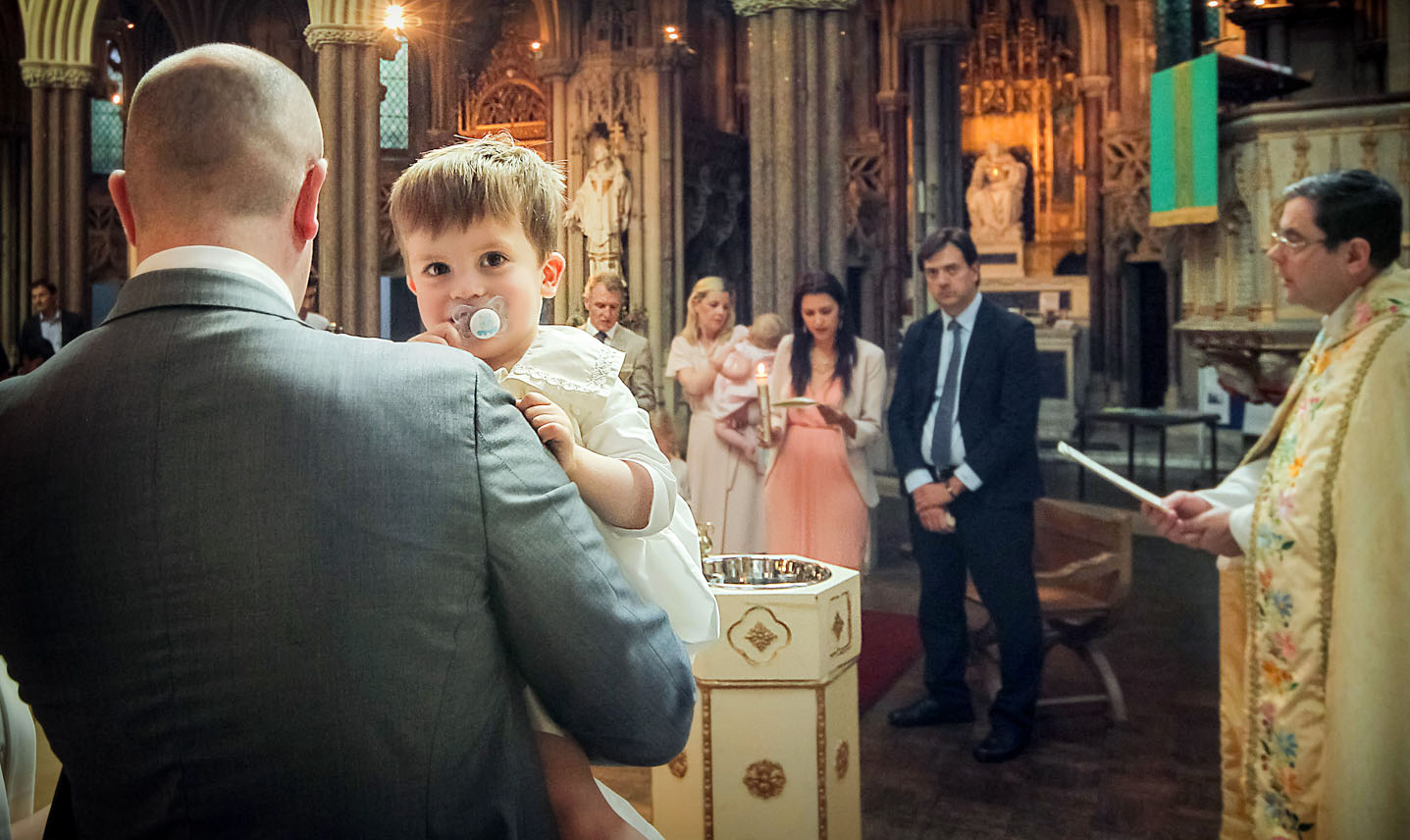 Christening photographer captures the catechism blessings during the baptism Christening photographer captures the catechism blessings during the baptism